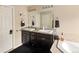 Bathroom featuring double sinks with granite countertops and dark wood cabinets at 3472 Harvard Pl, Broomfield, CO 80023