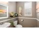Charming powder room with a pedestal sink, decorative mirror, and stylish wall art at 3472 Harvard Pl, Broomfield, CO 80023
