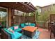 Cozy covered deck with comfortable seating around a fire pit, ideal for relaxing and enjoying the outdoors at 3472 Harvard Pl, Broomfield, CO 80023
