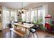 Sunlit dining room with modern decor, including large windows and a stylish chandelier, creating an inviting space for gatherings at 3472 Harvard Pl, Broomfield, CO 80023