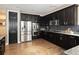 Modern kitchen with stainless steel appliances, dark cabinets, subway tile backsplash and ample counter space for cooking preparation at 3472 Harvard Pl, Broomfield, CO 80023