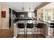 Spacious kitchen features sleek black cabinetry, a large center island, and stainless steel appliances, perfect for culinary enthusiasts at 3472 Harvard Pl, Broomfield, CO 80023