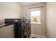 A bright laundry area with updated appliances and a window providing natural light at 3472 Harvard Pl, Broomfield, CO 80023