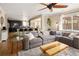 Open-concept living room boasts a ceiling fan, comfortable seating, and seamless flow to the kitchen, perfect for modern living at 3472 Harvard Pl, Broomfield, CO 80023