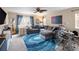 Comfortable living room showcasing a gray sectional, drum set, and large blue accent rug at 3472 Harvard Pl, Broomfield, CO 80023