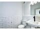 Half bathroom featuring subway tile detail, modern fixtures, and pedestal sink at 2 N Pennsylvania St, Denver, CO 80203