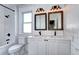 Bright bathroom featuring subway tile, double vanity with framed mirrors and modern fixtures at 2 N Pennsylvania St, Denver, CO 80203
