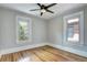 A charming bedroom features hardwood floors, neutral walls and trim, and two bright windows at 2 N Pennsylvania St, Denver, CO 80203