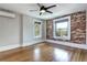 Bedroom with hardwood floors, brick accent wall, and natural light from two windows at 2 N Pennsylvania St, Denver, CO 80203