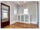 Elegant dining area featuring hardwood floors, custom built-ins, and unique windows at 2 N Pennsylvania St, Denver, CO 80203