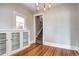 Elegant dining area featuring hardwood floors, custom built-ins, and unique window at 2 N Pennsylvania St, Denver, CO 80203