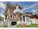 Exterior view of home showing brick, white trim, porch, and walkout basement access at 2 N Pennsylvania St, Denver, CO 80203