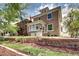 Well-maintained home exterior features a brick facade, manicured lawn, and charming landscaping at 2 N Pennsylvania St, Denver, CO 80203