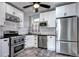 Updated kitchen featuring stainless steel appliances, white cabinets, and dark countertops at 2 N Pennsylvania St, Denver, CO 80203