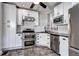 Modern kitchen featuring stainless steel appliances, white cabinets and subway tile backsplash at 2 N Pennsylvania St, Denver, CO 80203