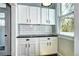 Bright kitchen space with white cabinets, subway tile backsplash, and dark countertops at 2 N Pennsylvania St, Denver, CO 80203