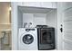 Laundry room space with washer, dryer, white subway tile, and sink at 2 N Pennsylvania St, Denver, CO 80203