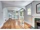 Open living area with hardwood floors, open archway to kitchen, and fireplace at 2 N Pennsylvania St, Denver, CO 80203