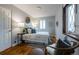 Cozy bedroom with stylish furnishings, natural light, and beautiful hardwood flooring at 1235 S Zenobia St, Denver, CO 80219