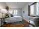 Well-lit bedroom featuring hardwood floors, complemented by neutral tones and comfortable decor at 1235 S Zenobia St, Denver, CO 80219