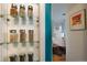 Close-up of kitchen storage cabinet shelves and view into dining area at 1235 S Zenobia St, Denver, CO 80219