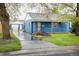 Charming blue bungalow with white trim, tidy landscaping and an inviting front porch at 1235 S Zenobia St, Denver, CO 80219