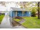 Charming blue house with white trim, landscaped yard, and a detached garage at 1235 S Zenobia St, Denver, CO 80219