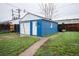 An exterior view of a detached garage and concrete path at 1235 S Zenobia St, Denver, CO 80219