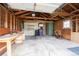 Inside the detached garage with open rafters, workbench and a concrete slab floor at 1235 S Zenobia St, Denver, CO 80219