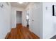 Bright hallway featuring hardwood floors and neutral paint, creating a welcoming entrance to the home at 1235 S Zenobia St, Denver, CO 80219