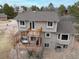 Aerial view of the house featuring a multi-tiered wooden deck with furniture and dining table at 8150 Tempest Ridge Way, Parker, CO 80134