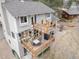 Aerial view of home with multi-level deck with dining table and lounge seating at 8150 Tempest Ridge Way, Parker, CO 80134