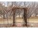 Stone pathway leading to a charming wooden arbor with climbing vines and garden beyond at 8150 Tempest Ridge Way, Parker, CO 80134