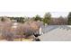 Backyard view showcasing the property's outdoor space and mature trees, with neighboring houses visible at 8150 Tempest Ridge Way, Parker, CO 80134
