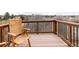 Relaxing deck area with a comfortable wooden chair, perfect for enjoying the peaceful surroundings at 8150 Tempest Ridge Way, Parker, CO 80134