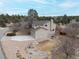 Beige two story house with a three car garage, stone landscaping, and a long concrete driveway at 8150 Tempest Ridge Way, Parker, CO 80134