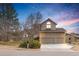 Charming two-story home with a well-manicured lawn, mature trees, and an attached two-car garage at 8150 Tempest Ridge Way, Parker, CO 80134