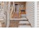 Inviting covered front porch featuring new steps, railing, and decorative accents at 8150 Tempest Ridge Way, Parker, CO 80134