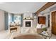 Comfortable living room with fireplace, neutral colors, and ample natural light at 8150 Tempest Ridge Way, Parker, CO 80134