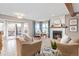 Cozy living room featuring a fireplace, plush seating, and access to an outdoor deck at 8150 Tempest Ridge Way, Parker, CO 80134