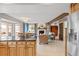 Open concept kitchen and living room with fireplace and hardwood floors at 8150 Tempest Ridge Way, Parker, CO 80134