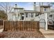 Charming townhome with a wooden fence, stone landscaping, and gated entryway at 378 Owl Dr, Louisville, CO 80027