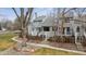 Charming gray townhouse featuring a private, fenced front yard and mature trees at 378 Owl Dr, Louisville, CO 80027