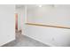 Bright hallway features neutral walls, plush carpet, and a wood railing at 378 Owl Dr, Louisville, CO 80027