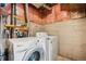 Unfinished laundry room features a washer and dryer, as well as unfinished walls and ceiling at 378 Owl Dr, Louisville, CO 80027