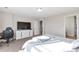 Spacious bedroom with bright lighting, a workspace, and a view of the closet at 12217 Skywalk St, Parker, CO 80134