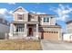 Inviting two-story home with stone accents, covered porch, and a front-facing two car garage at 12217 Skywalk St, Parker, CO 80134