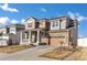 Charming two-story home featuring stone accents, a covered porch, and a well-maintained front yard at 12217 Skywalk St, Parker, CO 80134