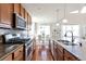 Gourmet kitchen features stainless steel appliances, granite countertops, and a mosaic backsplash at 12217 Skywalk St, Parker, CO 80134