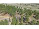 A secluded home nestled among many trees is shown in this scenic aerial view at 24699 Us Hwy 40, Golden, CO 80401
